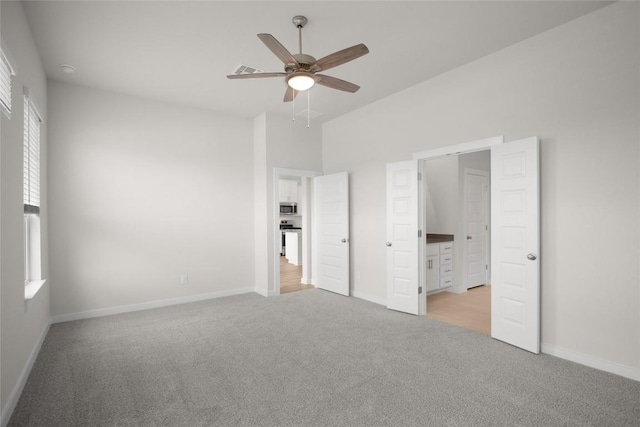 unfurnished bedroom featuring light carpet, visible vents, ceiling fan, and baseboards