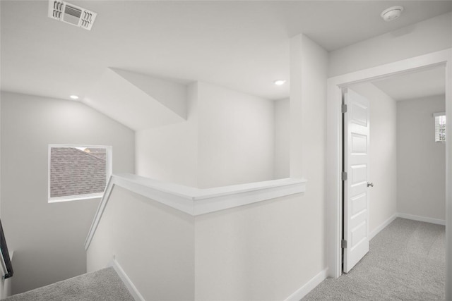 hallway with visible vents, baseboards, an upstairs landing, carpet flooring, and recessed lighting