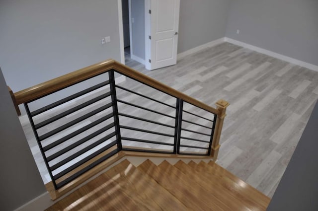 staircase featuring light hardwood / wood-style floors