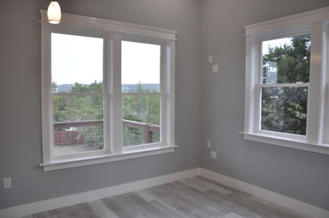 spare room with hardwood / wood-style floors