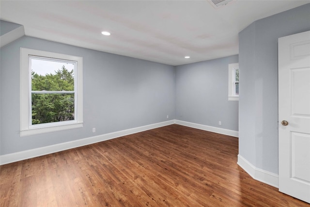 empty room with dark wood-type flooring