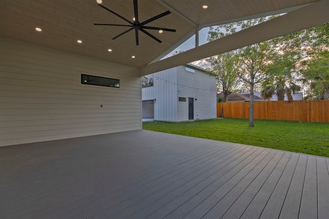 wooden deck with ceiling fan and a yard