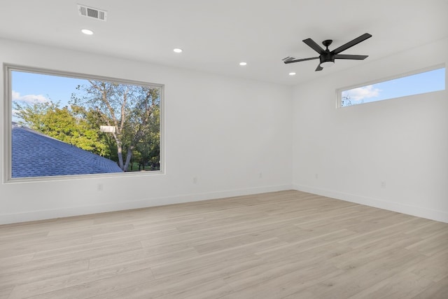 empty room with ceiling fan and light hardwood / wood-style floors