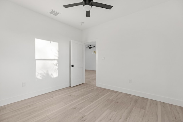 empty room with light hardwood / wood-style flooring and ceiling fan