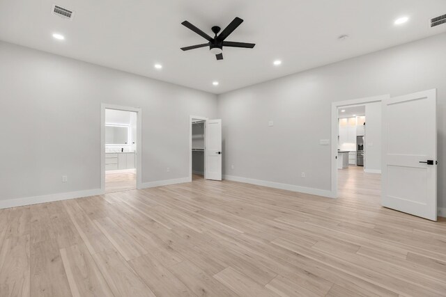 unfurnished room featuring ceiling fan and light wood-type flooring