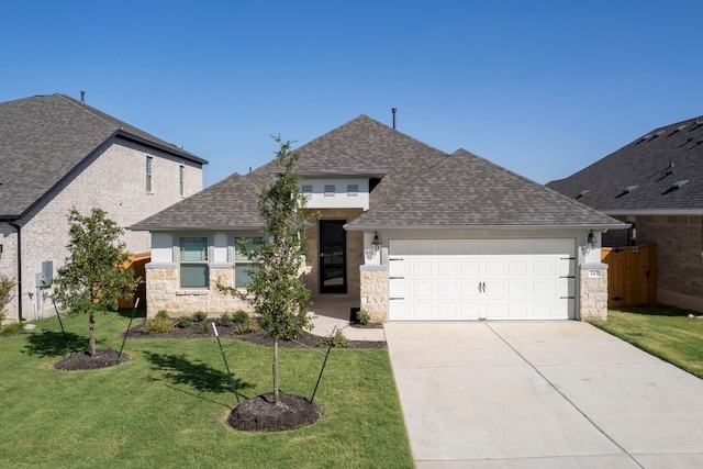 view of front of home featuring a front lawn and a garage