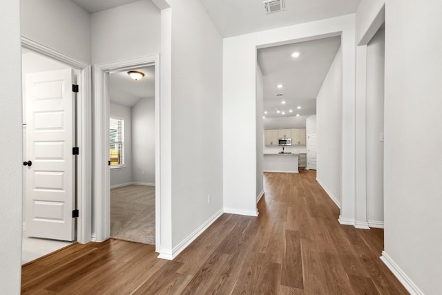 corridor featuring dark hardwood / wood-style floors