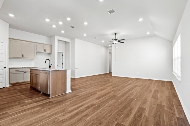 kitchen with an island with sink, wood-type flooring, ceiling fan, and dishwasher