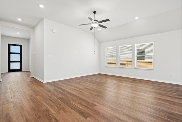 empty room featuring dark hardwood / wood-style floors, ceiling fan, and a wealth of natural light