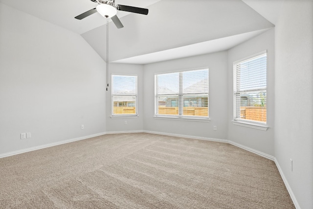 spare room with light carpet, vaulted ceiling, and ceiling fan