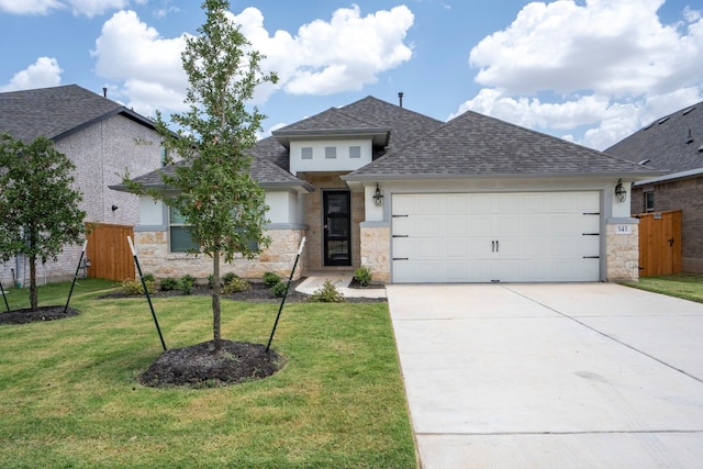 view of front of property featuring a front yard and a garage