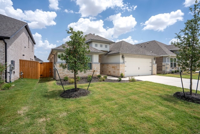 view of front of house featuring a front yard and a garage