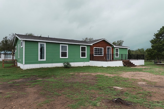 rear view of property featuring a wooden deck