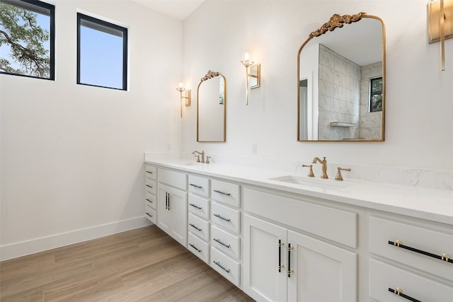 bathroom featuring hardwood / wood-style floors, large vanity, and double sink