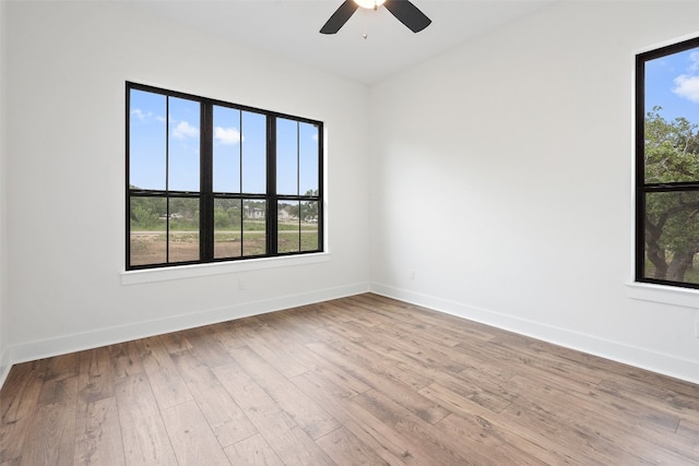 unfurnished room with plenty of natural light, ceiling fan, and light hardwood / wood-style floors