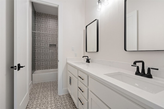 bathroom featuring double sink vanity, tiled shower / bath, and tile floors