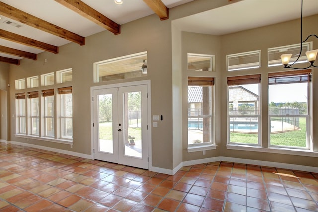 doorway with an inviting chandelier, a high ceiling, light tile patterned flooring, french doors, and beamed ceiling