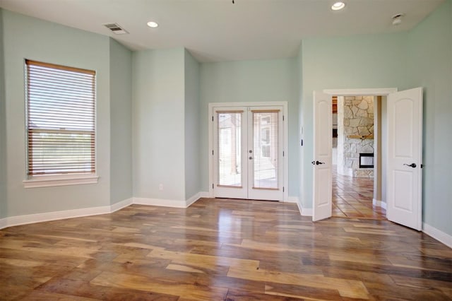 entryway featuring visible vents, wood finished floors, a wealth of natural light, and french doors