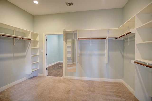 walk in closet with carpet flooring