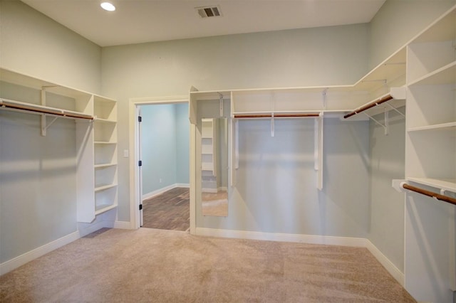 walk in closet featuring visible vents and carpet flooring