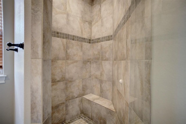 interior details featuring tiled shower