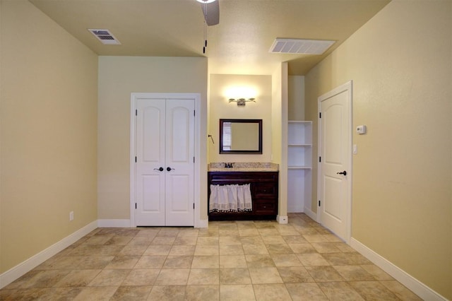 interior space featuring a closet, visible vents, and baseboards