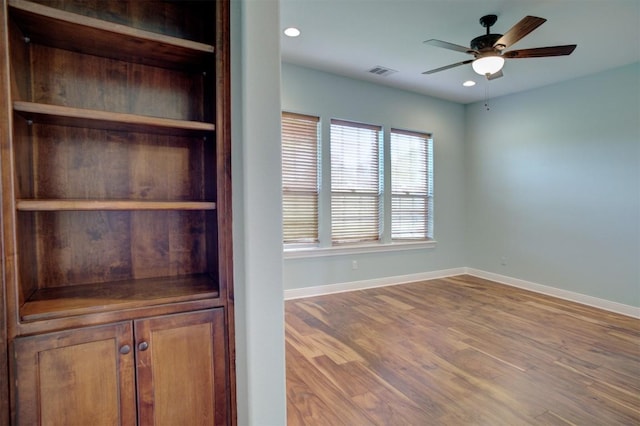 interior space with baseboards, visible vents, ceiling fan, wood finished floors, and recessed lighting