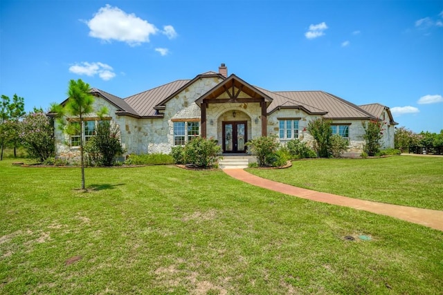 view of front of property featuring french doors and a front lawn