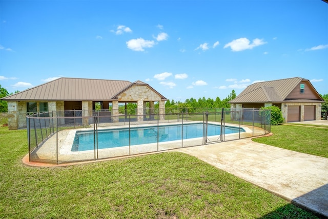 view of swimming pool featuring a patio area and a lawn