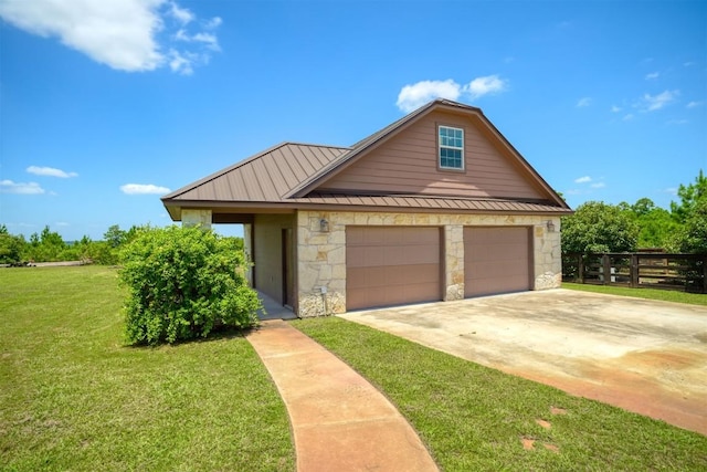 view of front of house featuring a garage, concrete driveway, metal roof, a standing seam roof, and a front yard