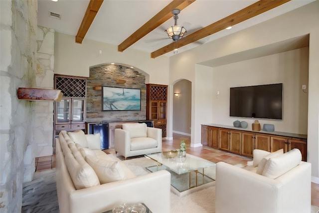 living room with beamed ceiling and indoor bar