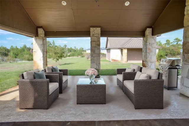 view of patio / terrace featuring area for grilling, an outbuilding, and an outdoor hangout area