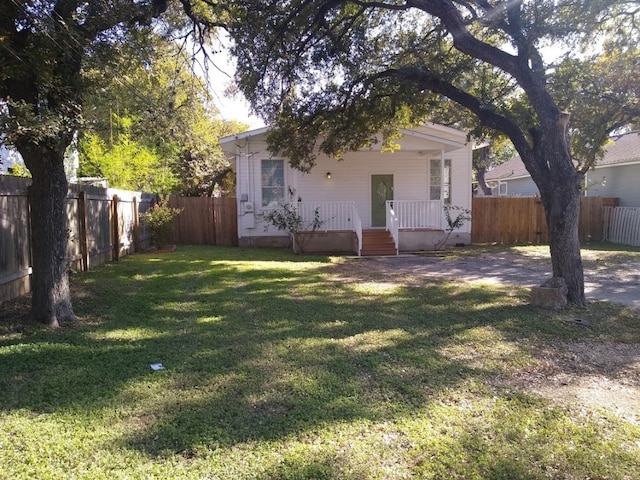 exterior space with a deck and a front lawn