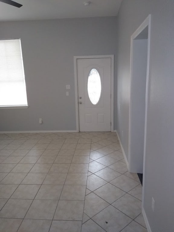 entrance foyer with ceiling fan and light tile floors