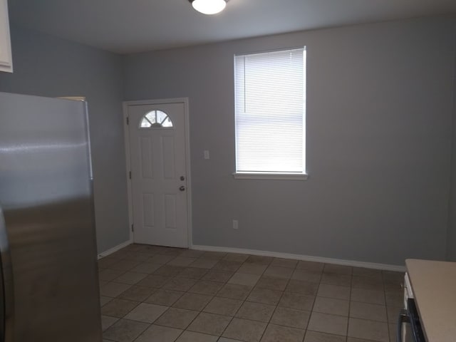 tiled entrance foyer featuring a healthy amount of sunlight