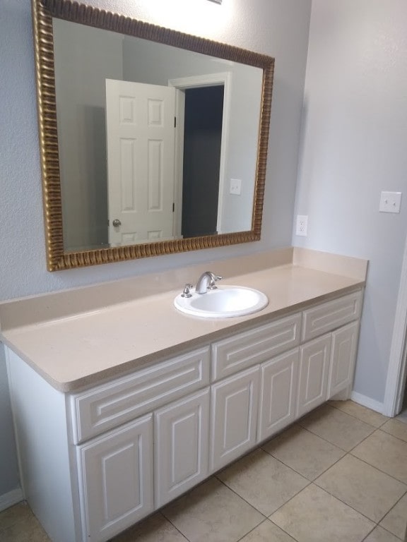 bathroom featuring tile flooring and vanity