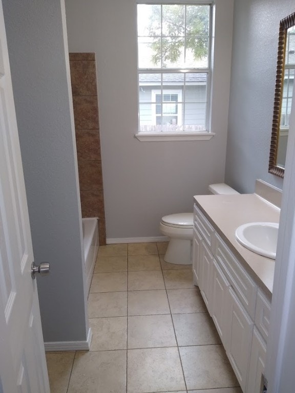 full bathroom featuring tile floors, toilet, vanity, and shower / bathtub combination