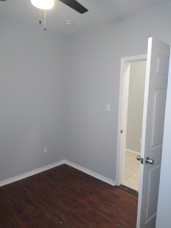 empty room featuring ceiling fan and hardwood / wood-style flooring