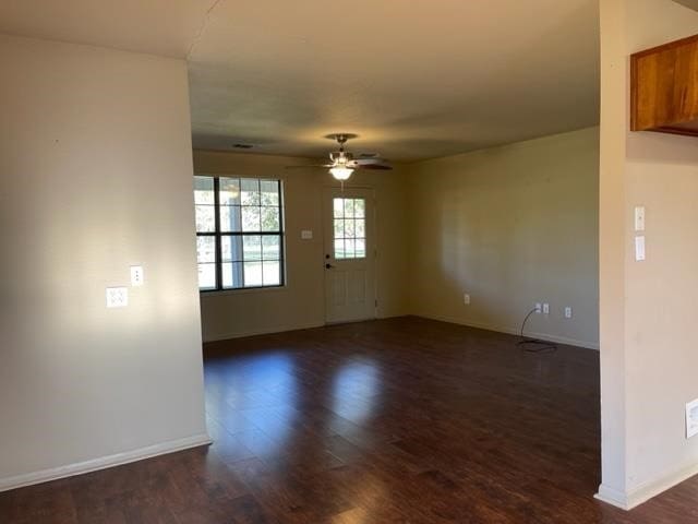 empty room featuring dark hardwood / wood-style flooring and ceiling fan