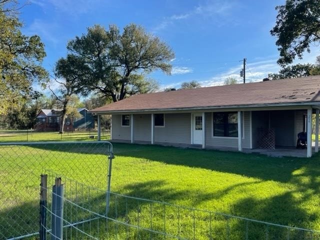 back of property featuring a yard