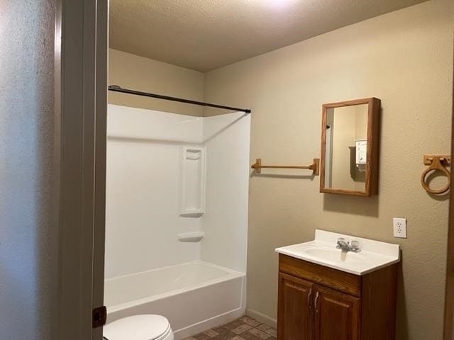 full bathroom with vanity, tub / shower combination, tile flooring, a textured ceiling, and toilet