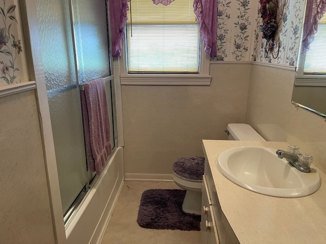 full bathroom with shower / bath combination with glass door, toilet, and large vanity