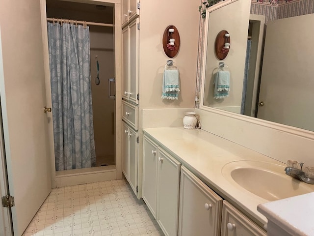 bathroom with walk in shower, tile floors, and vanity