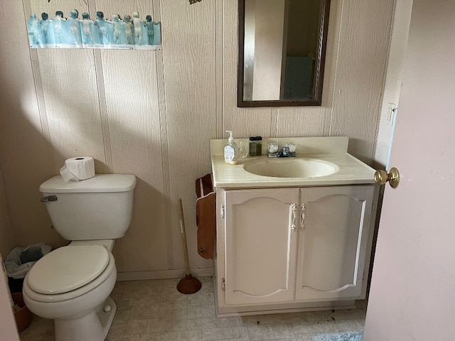 bathroom with vanity, tile floors, and toilet