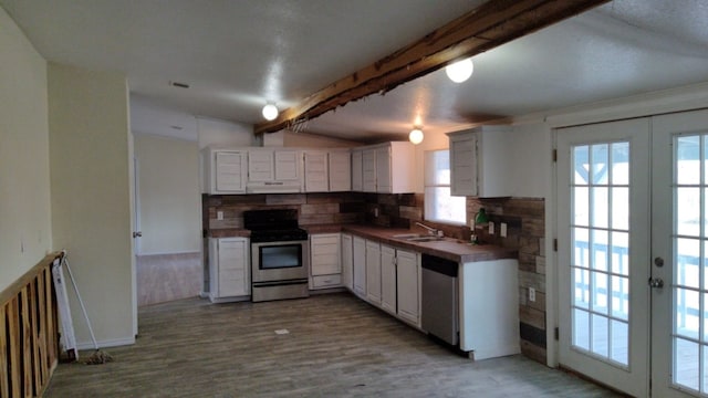 kitchen featuring light hardwood / wood-style flooring, white cabinetry, stainless steel appliances, beam ceiling, and tasteful backsplash