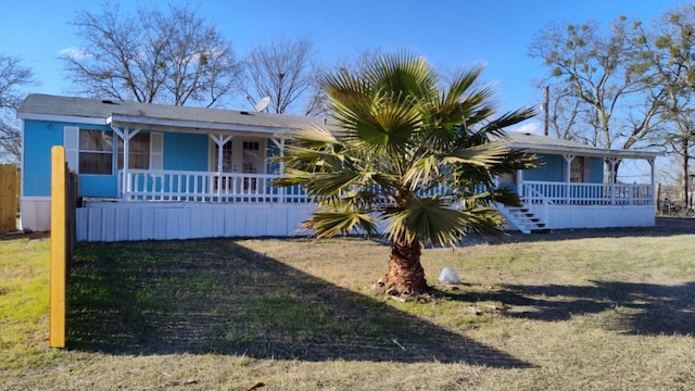 view of front of property with covered porch and a front yard