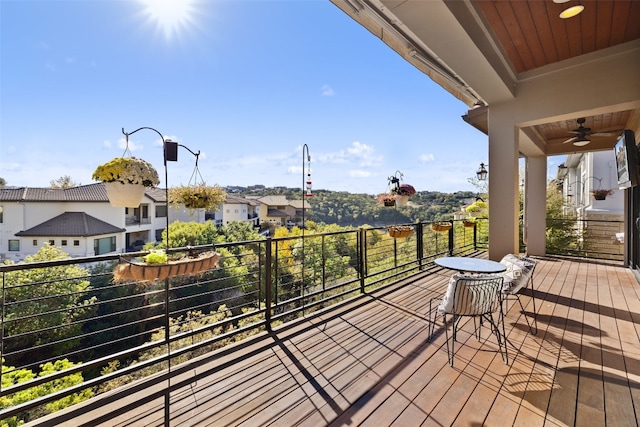 wooden deck with a ceiling fan and a residential view