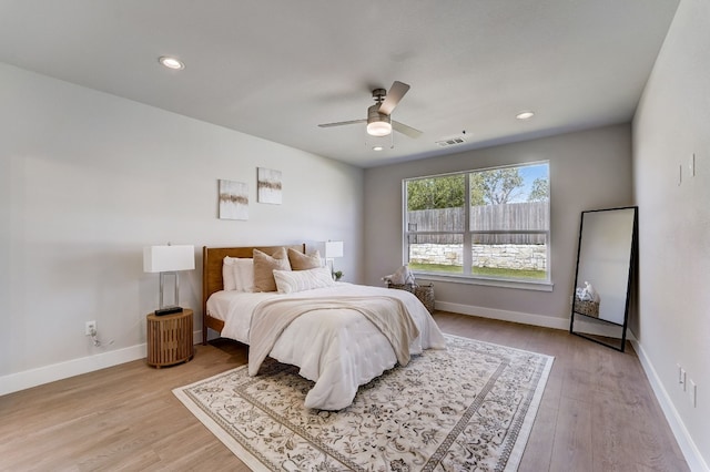 bedroom with ceiling fan and light wood-type flooring