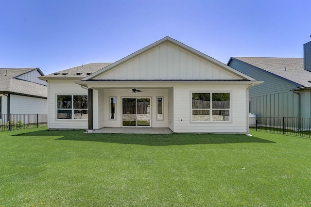 rear view of property featuring a lawn, ceiling fan, and a patio area