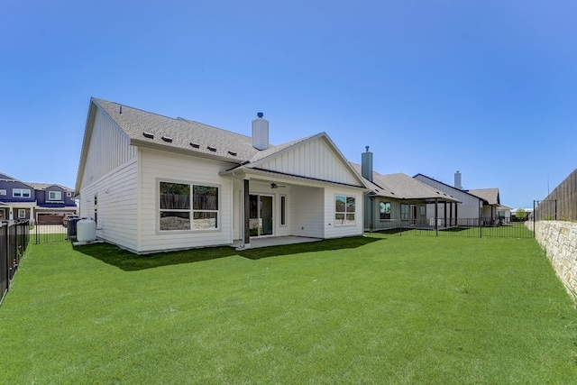 rear view of property featuring a patio, ceiling fan, and a lawn